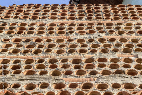 Bottom shoot of old masonry perforated brick wall