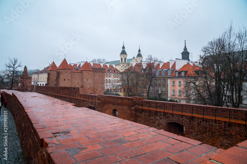 Warsaw, Poland Famous Barbican old town historic capital city during rainy winter day and red orange brick wall fortress architecture.