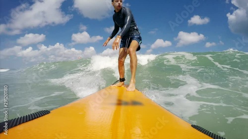 Great timelapse go pro portrait of athletic man surfing in the ocean and falling into water with splash. Bali, Indonesia