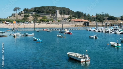 Boats in Baiona Harbour and Fortress in Background photo