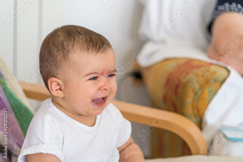 baby crying with discomfort and fever incubating the flu virus