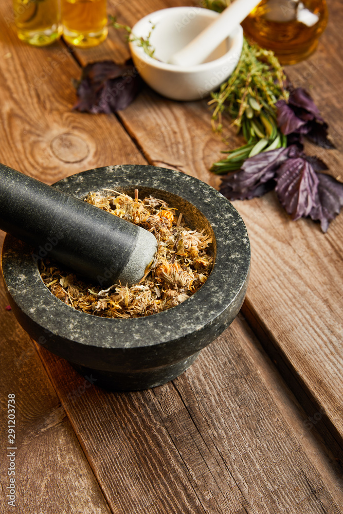 mortars with pestles with herbal mix near fresh basil on wooden surface mortars with pestles with herbal mix near fresh basil on wooden surface
