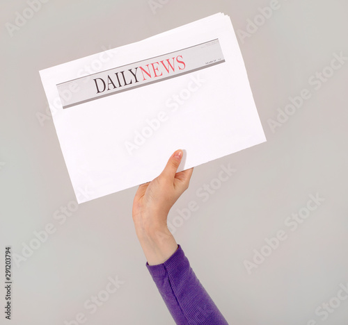 hand holding an newspaper