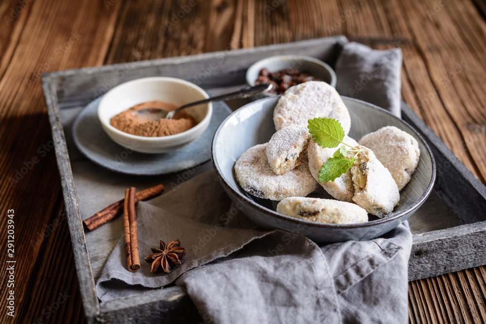 Classic Welsh cakes with raisins, sprinkled with powdered sugar Classic Welsh cakes with raisins, sprinkled with powdered sugar