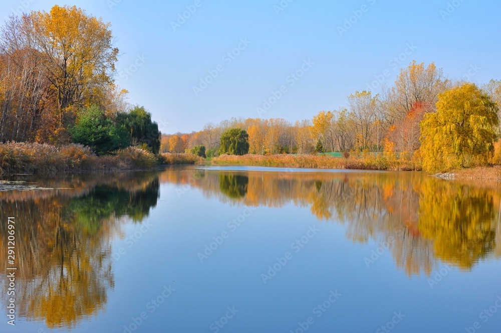 Water Reflected Autumn Colors With Blue Sky Water Reflected Autumn Colors With Blue Sky