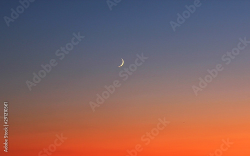 Red sunset with crescent moon in Brighton