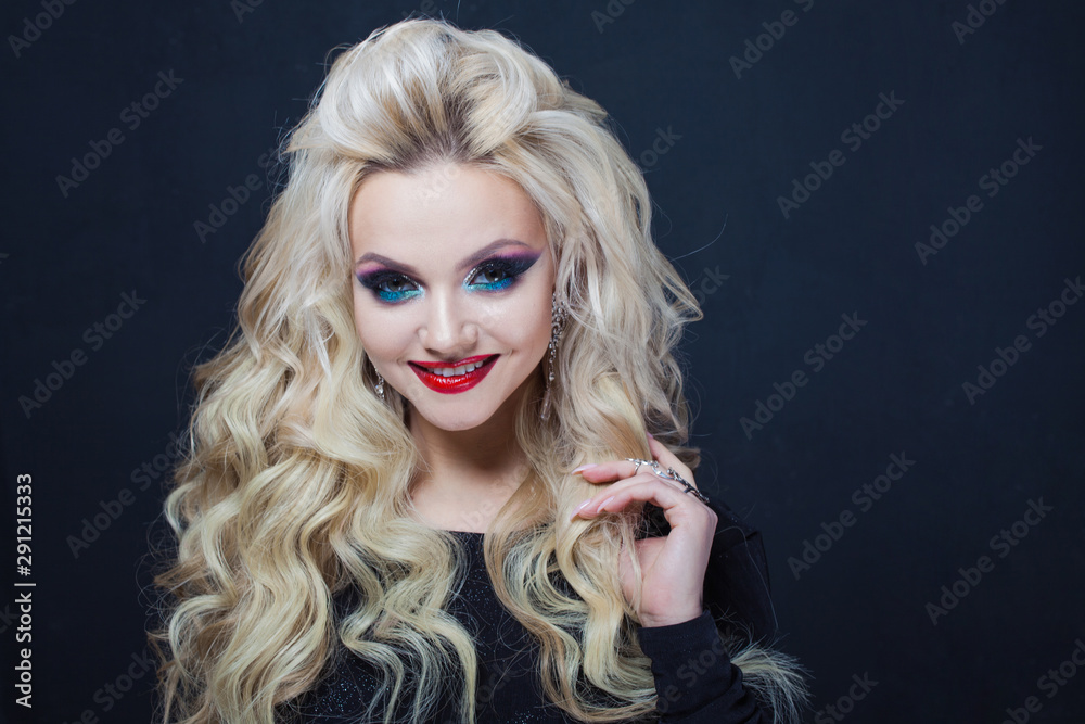 Portrait of a young luxurious blonde with long curls. Portrait of a young luxurious blonde with long curls.