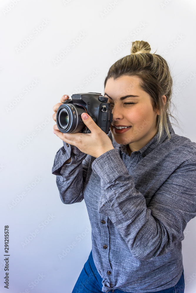 Woman photographer standing with camera photographing Woman photographer standing with camera photographing
