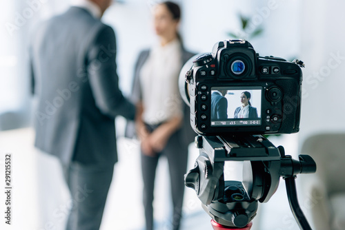 Photography selective focus of digital camera shooting journalist and businessman