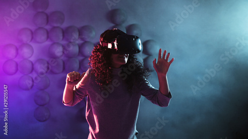 gamer in virtual reality, a girl plays a game or explores the environment in a simulation.