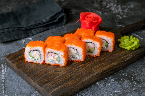 California roll with crab on the board on grey concrete table