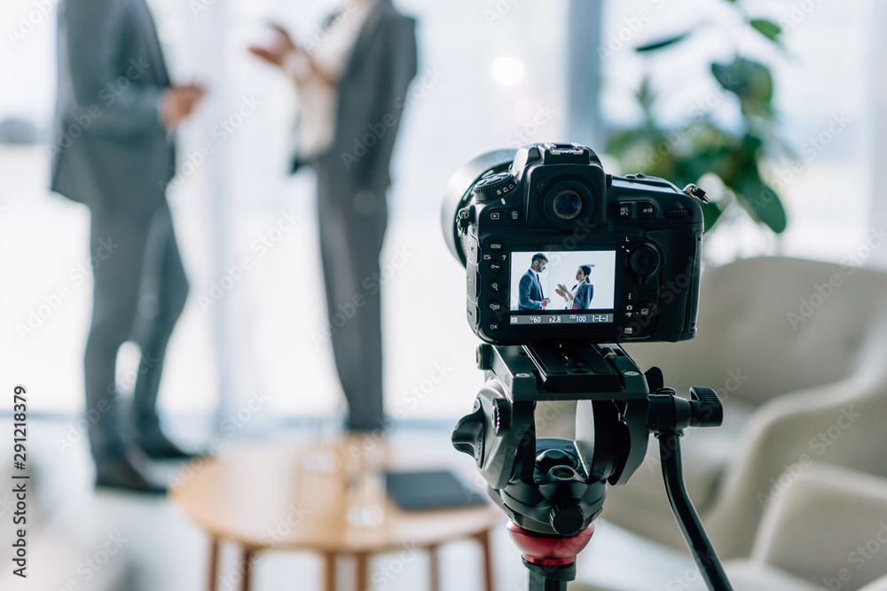 selective focus of digital camera shooting journalist and businessman