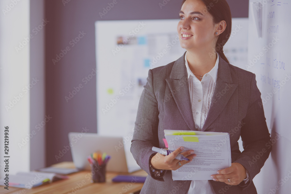 Business, education and office concept - business team with flip board in office discussing something. Business, education and office concept - business team with flip board in office discussing something.