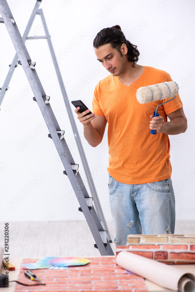 Young man contractor doing renovation at home Young man contractor doing renovation at home