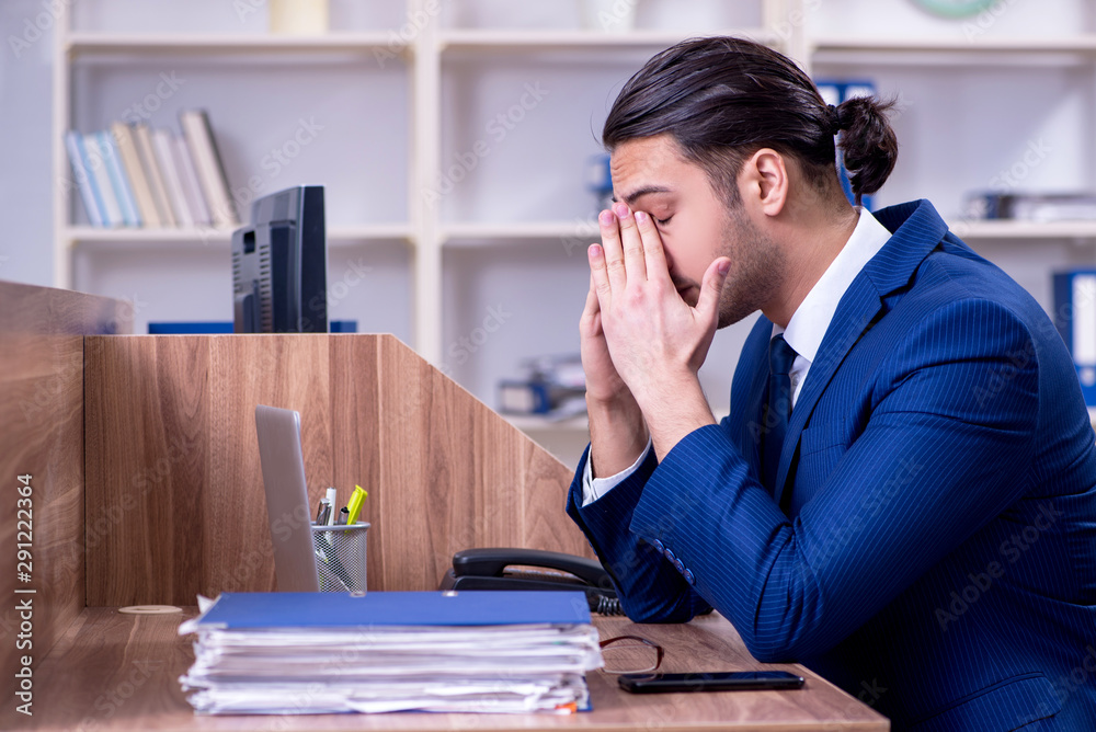 Young handsome businessman working in the office Young handsome businessman working in the office