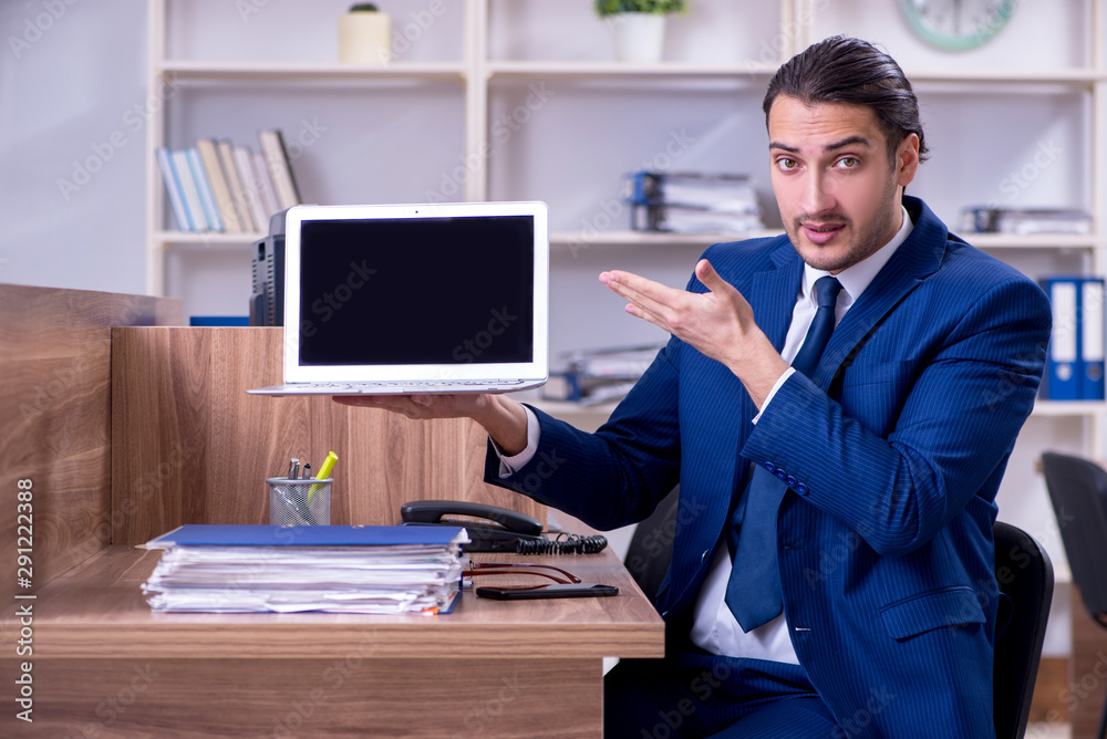 Young handsome businessman working in the office Young handsome businessman working in the office