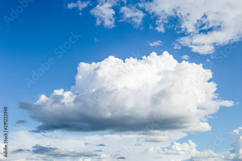 White rain cloud floating over clear blue sky, weather and season concept background © sirirak