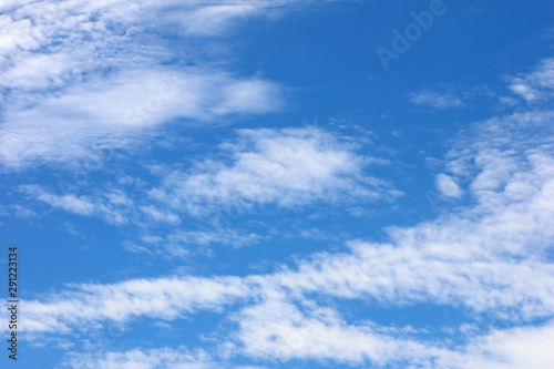 The vast blue sky background and white clouds