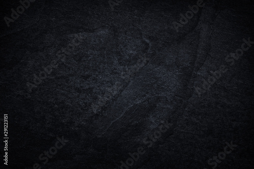 Dark grey black slate background or natural black stone texture.