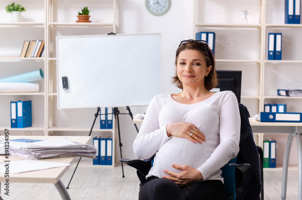Old pregnant woman working in the office Old pregnant woman working in the office