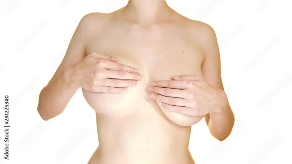 Close-up static shot of a naked lady with her hands covering her breasts while lifting one of them Close-up static shot of a naked lady with her hands covering her breasts while lifting one of them