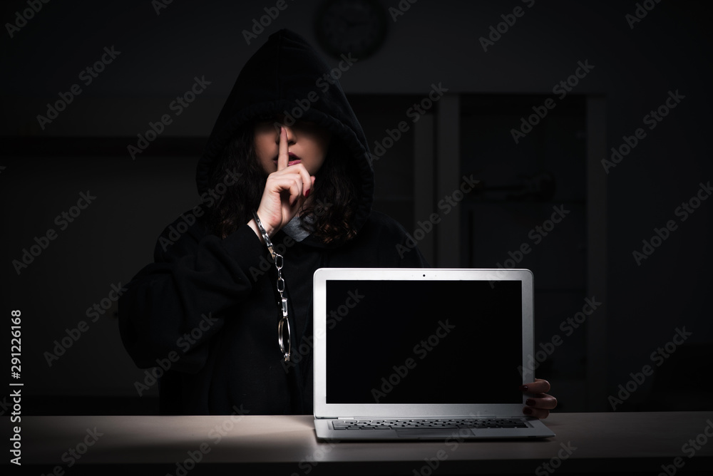 Female hacker hacking security firewall late in office Female hacker hacking security firewall late in office