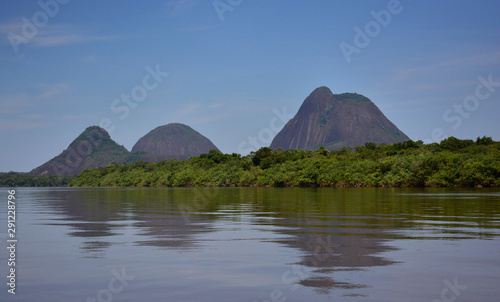 The Guainía river and the Cerros de Mavicure. Three hills, located in Colombia.The three mountains, Pajarito (Little Bird), Mono (Monkey) and Mavicure photo