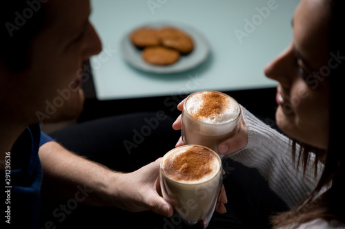 Romantic couple drinking coffee in their home