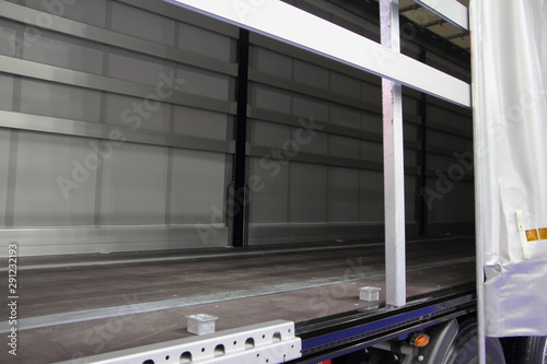 Obraz na płótnie New truck empty semi trailer with removable curtains, indoor side view close-up, lorry transportation logistics with side loading w salonie