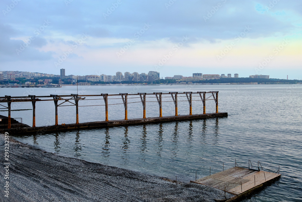 Fototapeta premium Sea at sunset, pier breakwater.