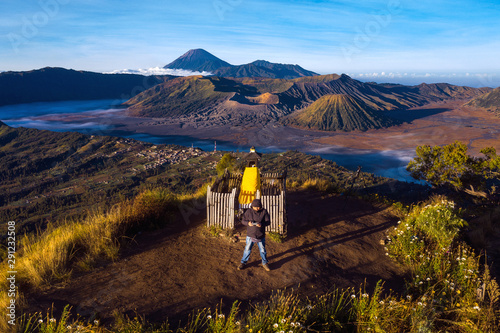 photographer on the top of mountain to take a sunrise photo by drone for Bromo vocano photo