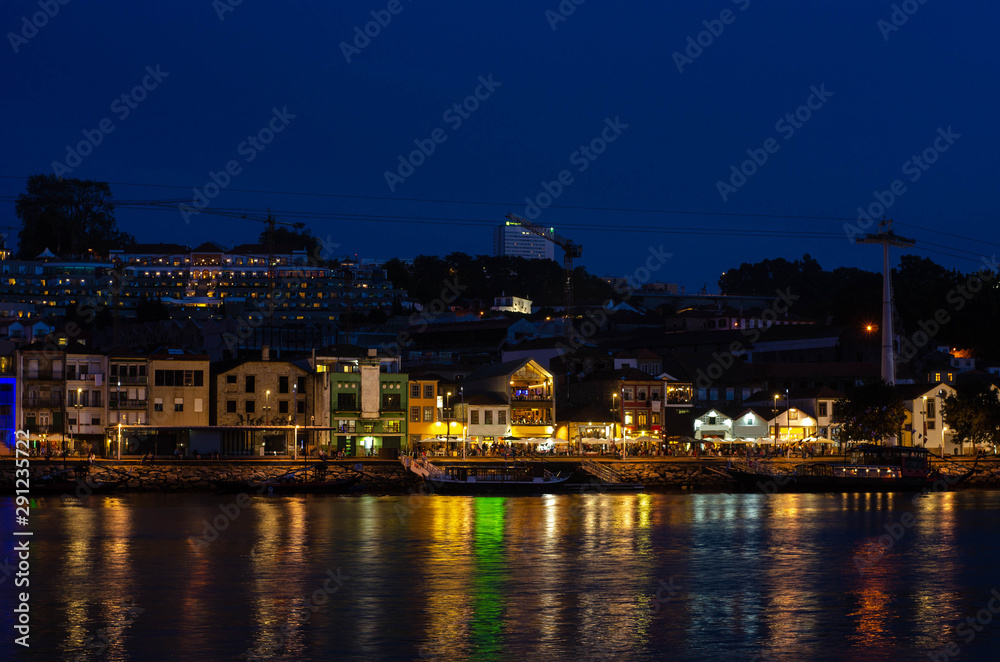 Douro river embankment at night, Ribeira district, Porto city on sunset, Portugal