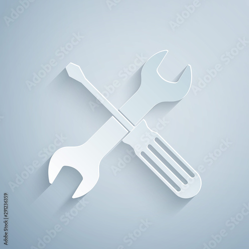 Paper cut Crossed screwdriver and wrench tools icon isolated on grey background. Service tool symbol. Paper art style. Vector Illustration