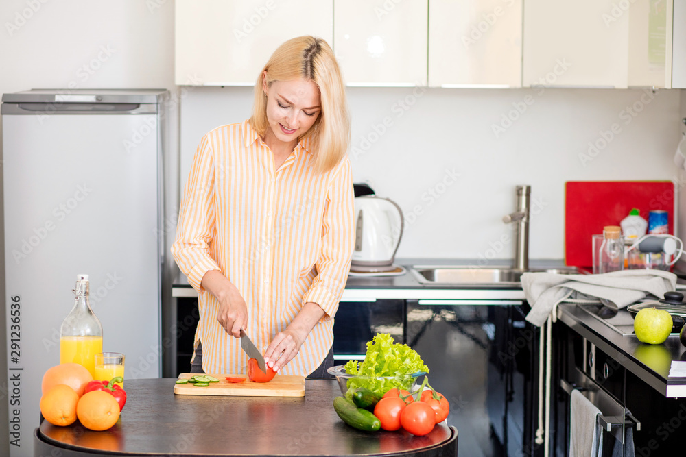 Young woman cooking in the kitchen