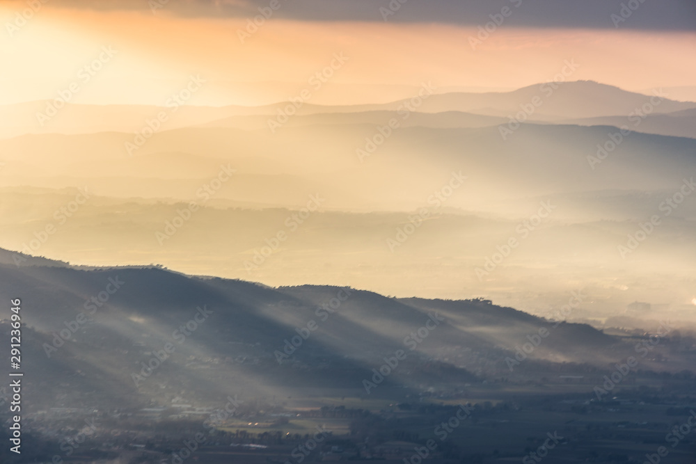 Sunrays coming over a valley in Umbria (Italy) with beautiful golden hours colors. Sunrays coming over a valley in Umbria (Italy) with beautiful golden hours colors.