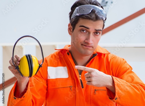 Worker showing the importnace of wearing noise cancelling headph photo