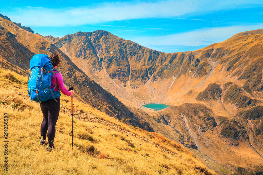 Happy sporty backpacker hiker woman in mountains, Carpathians, Transylvania, Romania