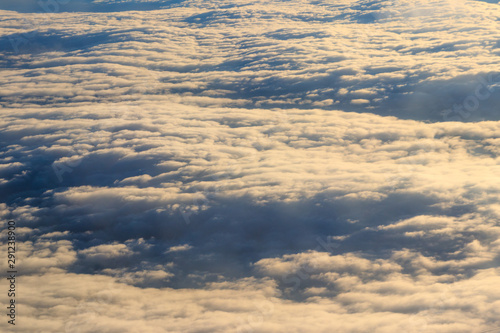 Beautiful white clouds in blue sky. View from airplane