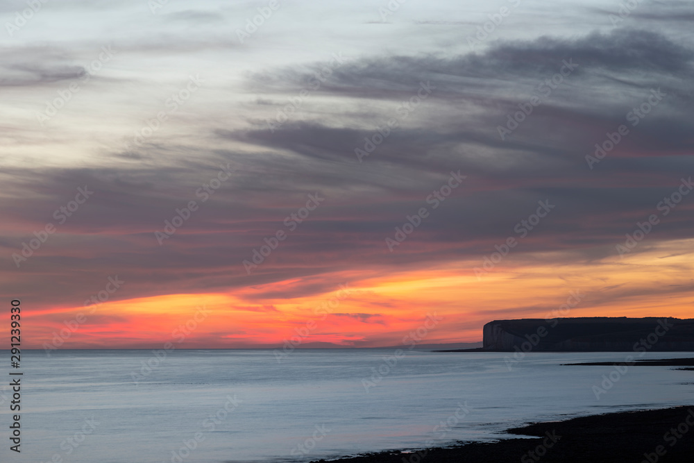 Beautiful vibrant Summer landscape sunset image of Seven Sisters chalk cliffs in England