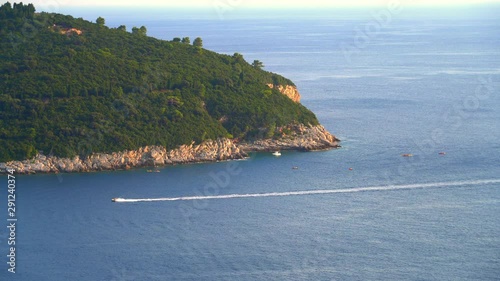 Speedboat swims past Lokrum island near Dubrovnik