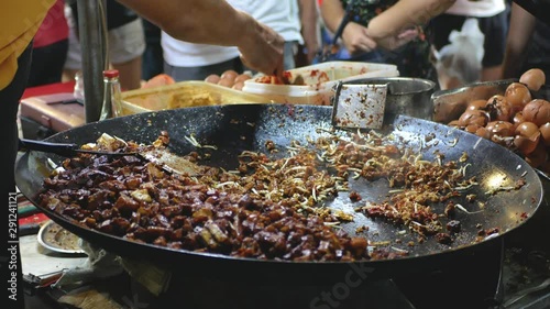 Street food vendor frying carrot cake at the night market. photo