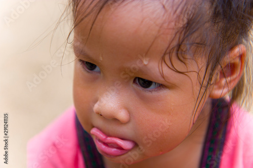 Toddler's Face looking for something and sweaty on her face .