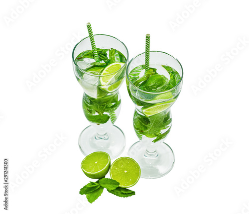 Two beautiful glasses with mojito and tubules. Isolated on white. Mint, rum, lime.