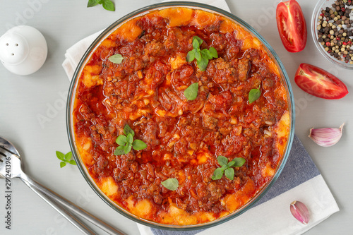 Meat casserole with potatoes, tomatoes and cheese.