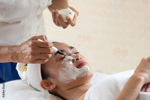 Beautiful Asian woman in mask on face in spa beauty salon  enjoying and relaxing time  skin care and healthcare concept