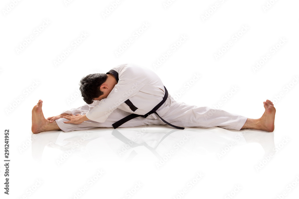 Male martial artist split and bend down isolated Male martial artist split and bend down isolated