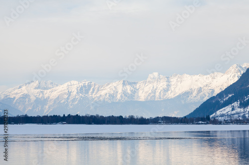 The view from the Austrian town of Zell am See across Lake Zell towards a winter landscape.