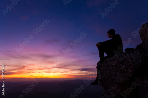 man thinking in sunset landscape