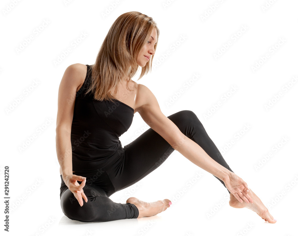 Young attractive blonde woman stretching on white background