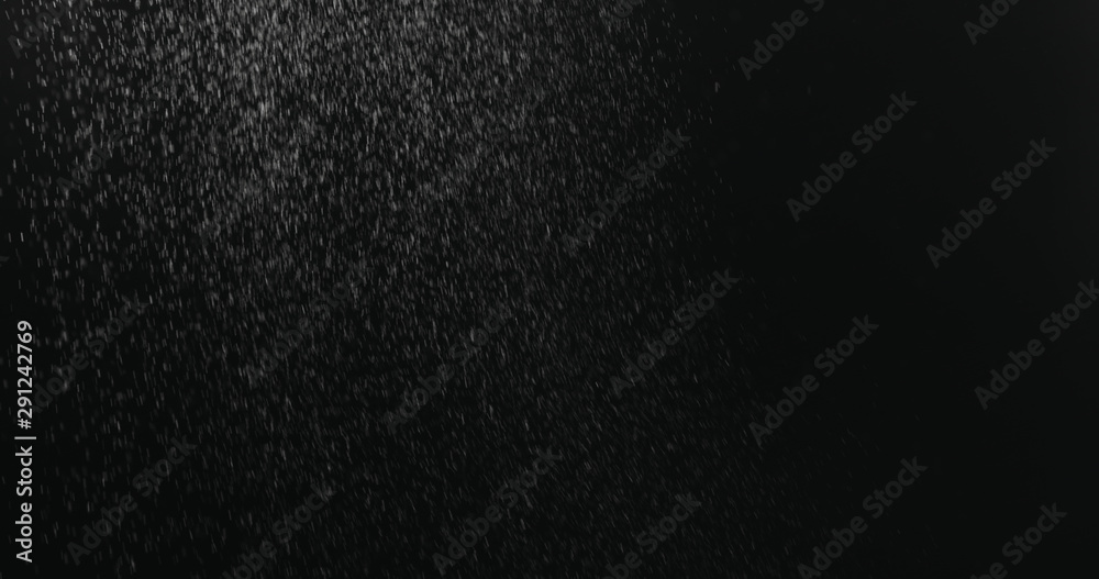 fine dust particles falling on black background fine dust particles falling on black background